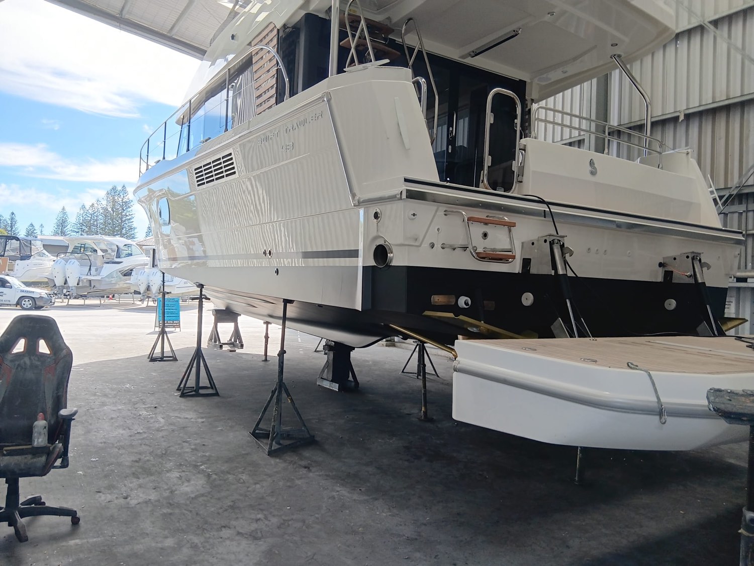 Beneteau Swift Trawler 48 finished in the shed, hull gleaming above a fresh black antifoul